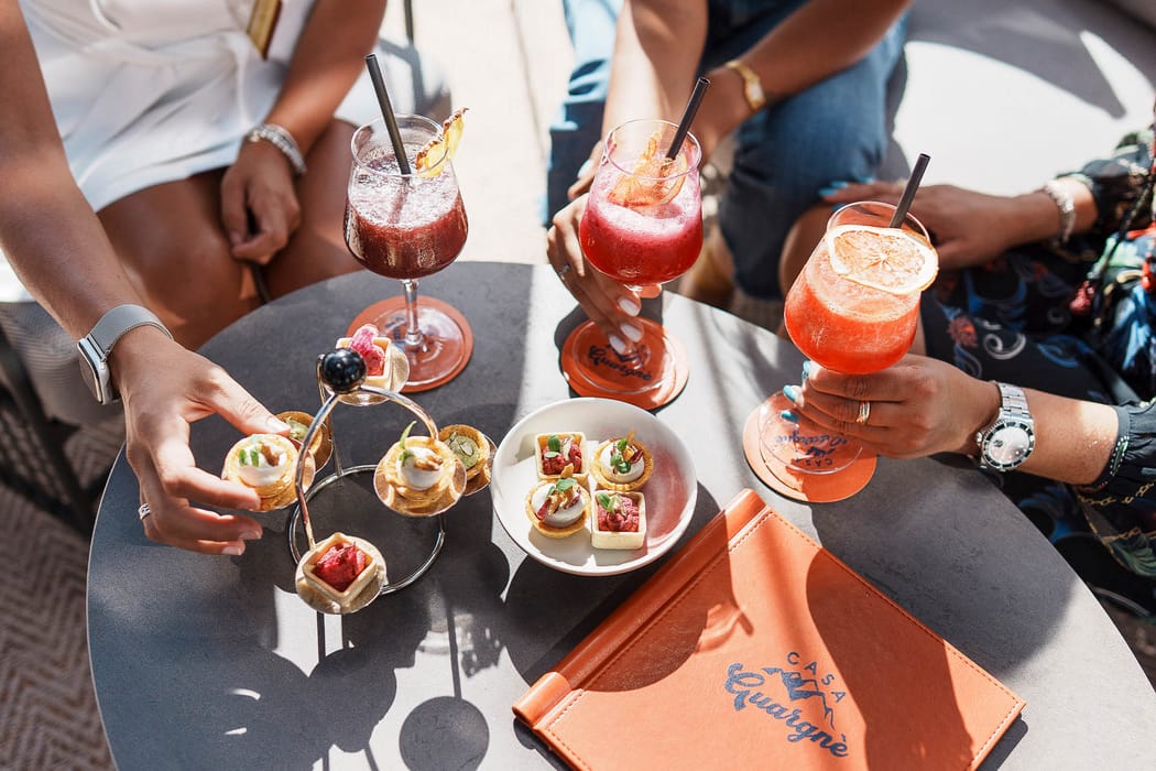 Aperitif with cocktails and snacks among friends