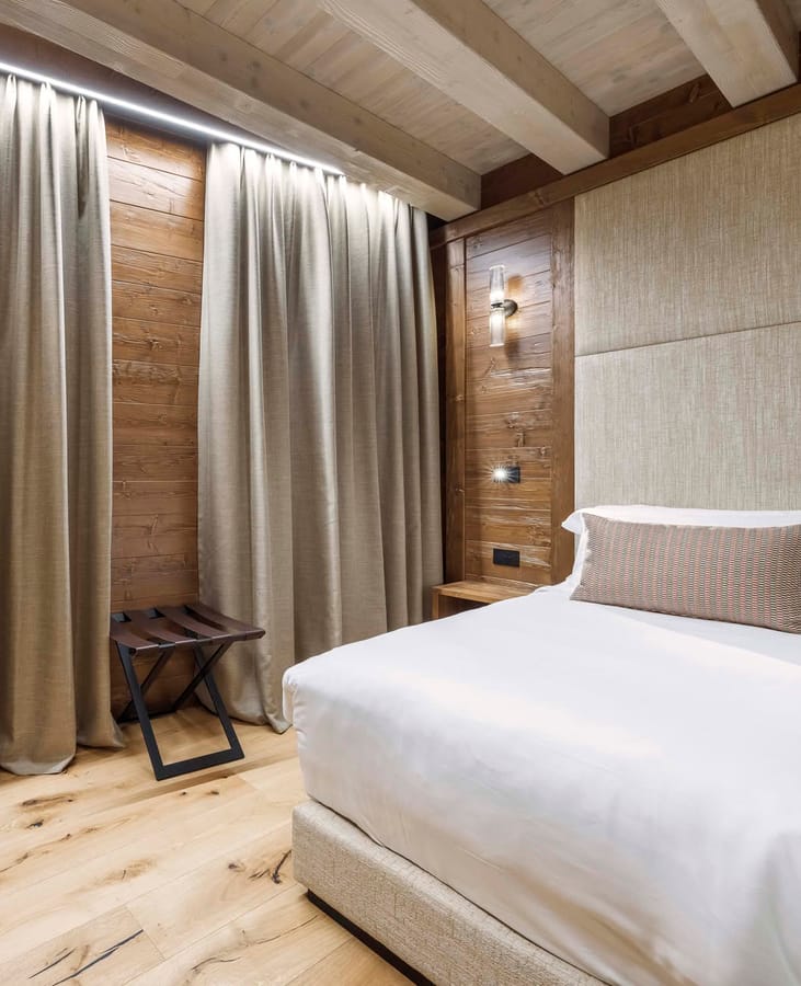 Dettaglio letto matrimoniale e poggia valigia Camera Family Casa Guargnè